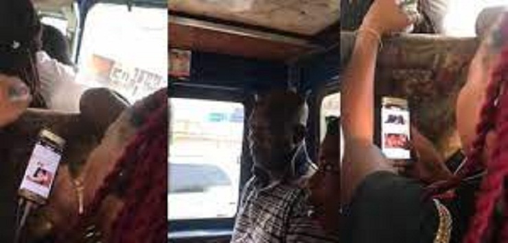 ‘Horny’ young lady filmed watching adult film in trotro loading passengers at a station (Video)